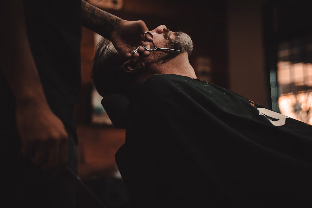 Barbershop scene with a clean haircut in progress and premium grooming details.