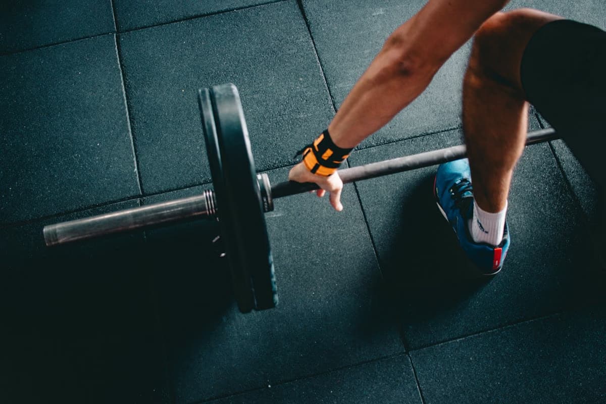 Modern gym interior with strength training equipment and dramatic lighting.