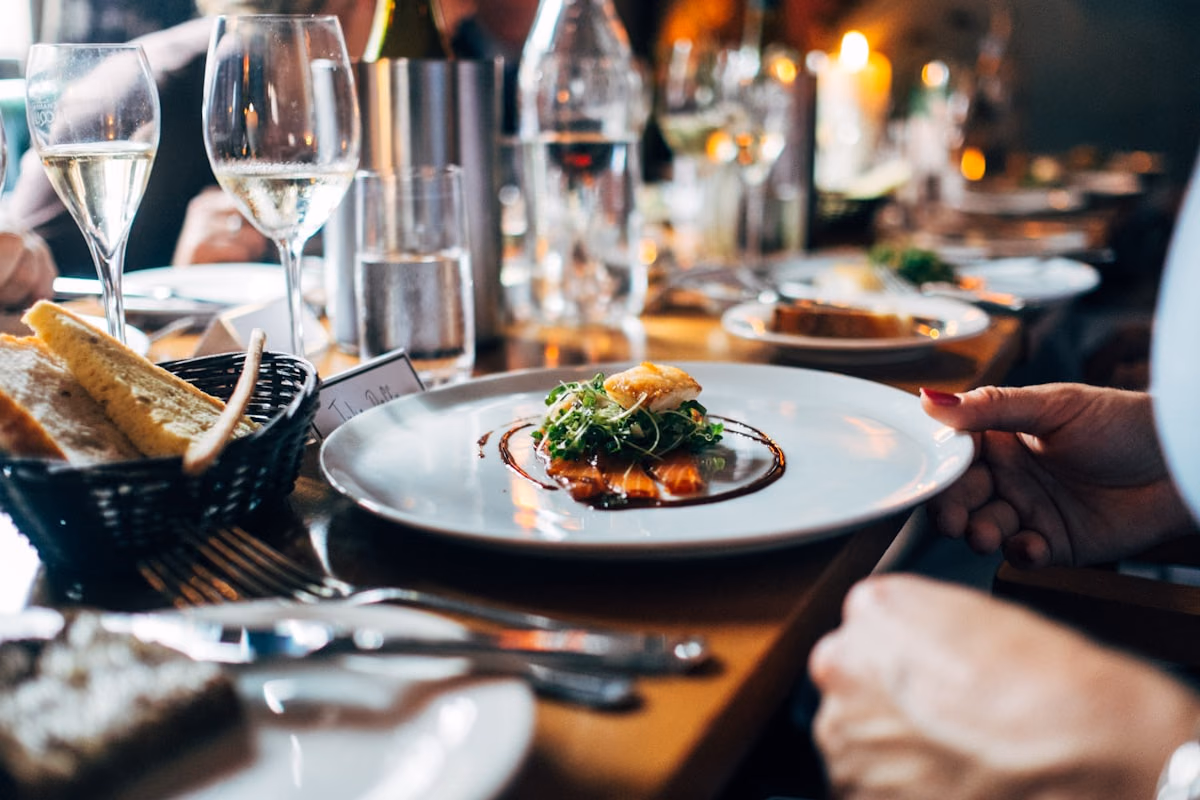 Elegant restaurant table with plated dishes and warm ambient lighting.